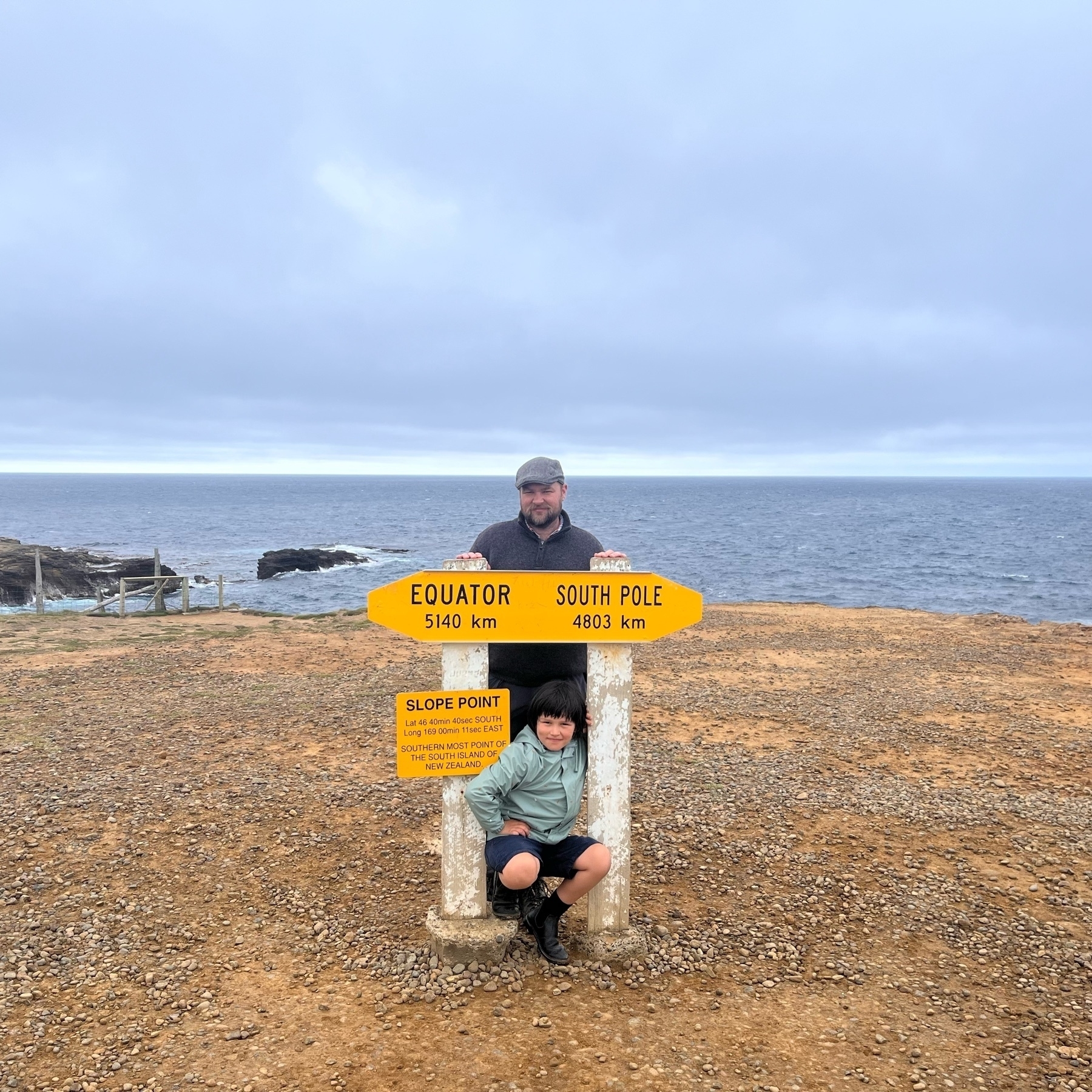 Anthony and Victor standing by the Slope Point sign which reads: EQUATOR
5140 km, SOUTH POLE
4803 km, SLOPE POINT
Lat 46 40min 40sec SOUTH,
Long 169 00min 11sec EAST, SOUTHERN MOST POINT OF THE SOUTH ISLAND OF
NEW ZEALAND.